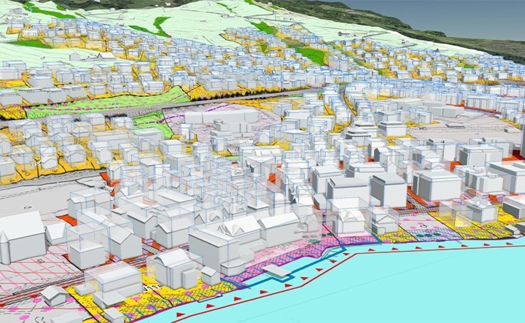 Une carte numérique en 3D montrant un paysage urbain avec des bâtiments en bleu transparent, des zones codées en couleur, des rues et un quartier portuaire, avec des collines et des zones vertes en arrière-plan.