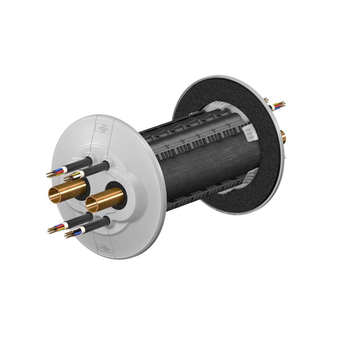 Ein zylindrisches industrielles Bauteil mit schwarzen und weißen Endplatten, goldenen Metallrohren und mehreren freiliegenden farbigen Drähten, die von beiden Seiten herausragen. Das Gerät scheint Teil eines mechanischen oder elektronischen Systems zu sein.