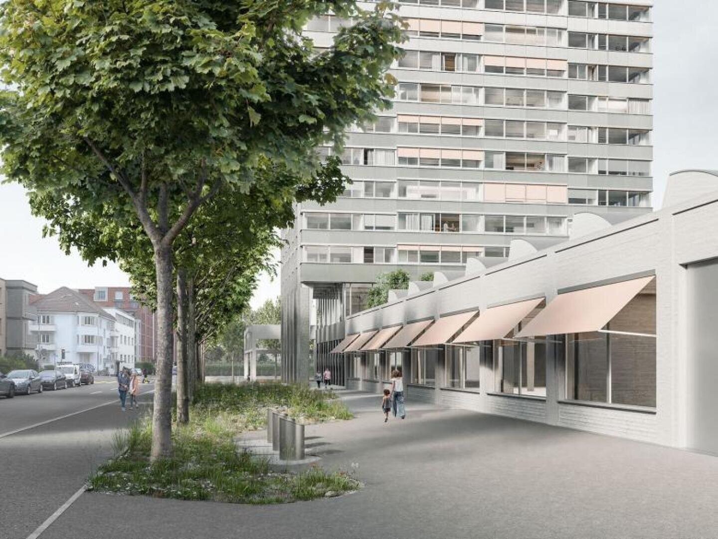 Eine Stadtstraße mit Bäumen, Bänken und einem breiten Bürgersteig neben einem modernen Gebäude mit großen Fenstern und braunen Markisen; dahinter erhebt sich ein hoher Wohnturm, in dessen Nähe ein paar Menschen spazieren gehen.