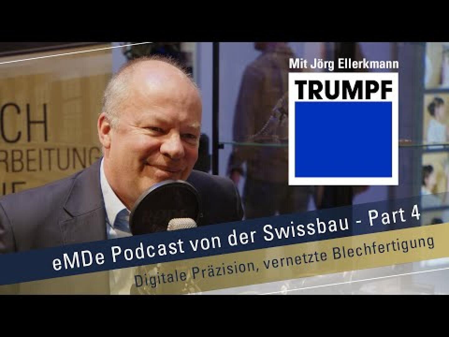 Ein Mann im Anzug sitzt lächelnd vor einem Mikrofon. Über dem Bild steht der Text Mit Jörg Ellerkmann TRUMPF und eMDe Podcast von der Swissbau - Part 4 Digitale Präzision, vernetzte Blechfertigung.